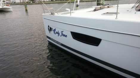 Bow lettering & graphics installed on Fountaine Pajot Catamaran in Tierra Verde the FL