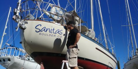 Vinyl boat name installed on canoe hull sailboat in Salt Creek St Petersburg