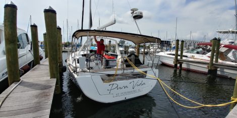 Coast Guard registration lettering installed on Benito sailboat at Lands End marina in Apollo Beach