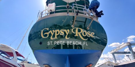 Gold "Gypsy Rose" sailboat name on a green hull