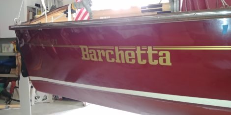 Custom gold stripe and name lettering on small classic sailboat in Tierra Verde FL