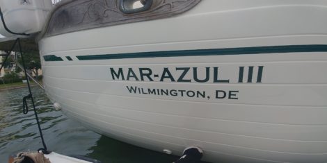 Custom vinyl boat name installed on canoe hull in Madeira Beach FL